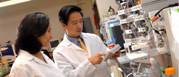 Two scientists looking at equipment