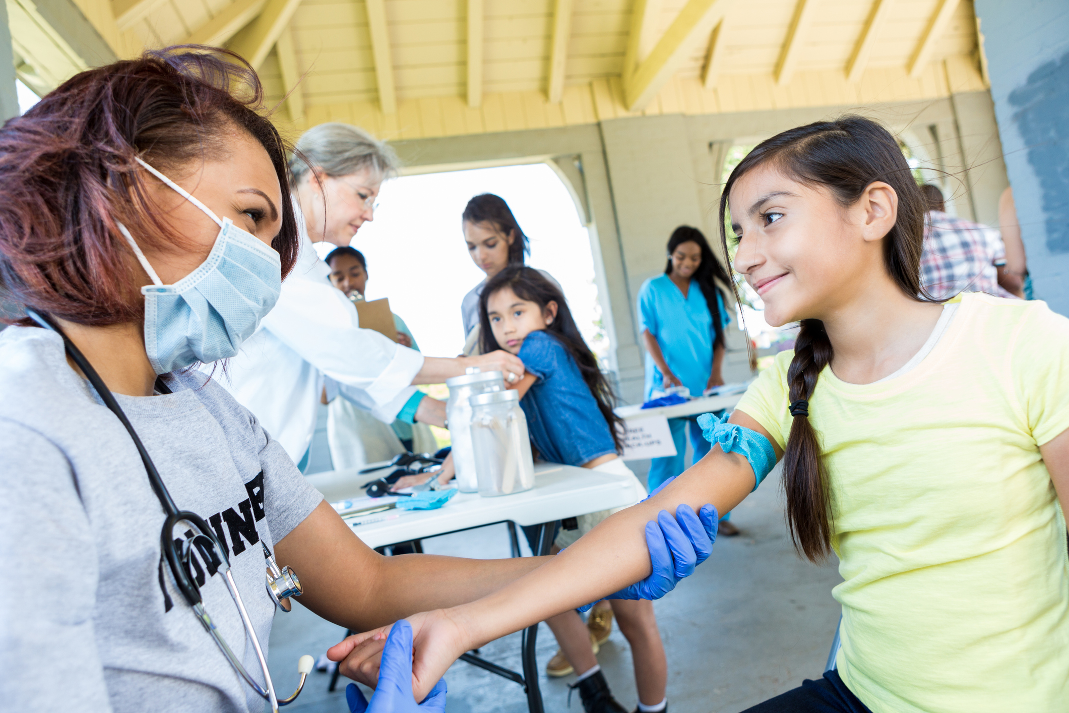 Girl participating in a community engagement health fair.